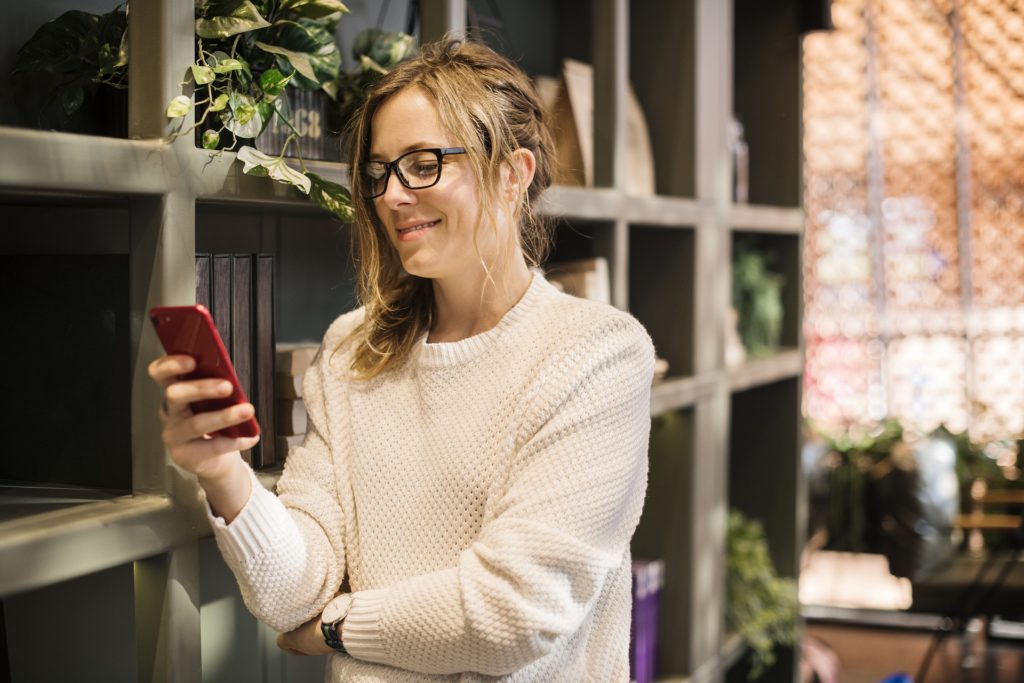 women checking text financing